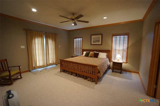 carpeted bedroom with crown molding and ceiling fan