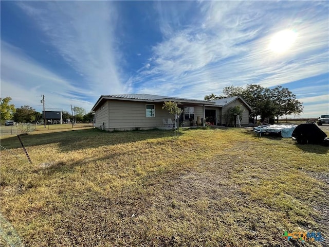 view of front of home with metal roof and a front yard