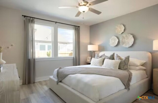 544 Bauer Loop, Liberty Hill, TX 78642 - bedroom featuring wood finished floors and ceiling fan