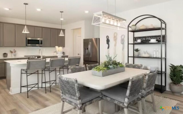 544 Bauer Loop, Liberty Hill, TX 78642 - dining room with light wood-style flooring and recessed lighting