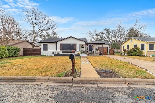 1011 Gilmore St, Taylor, TX 76574 - view of front of house with fence, a front lawn, and driveway