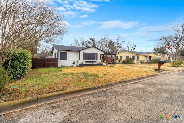 1011 Gilmore St, Taylor, TX 76574 - bungalow with fence and a front yard