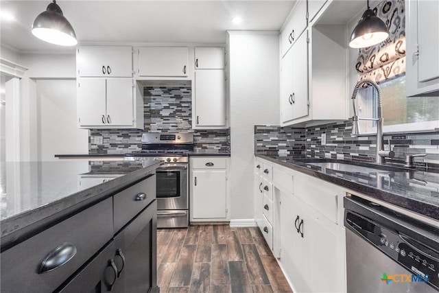 1011 Gilmore St, Taylor, TX 76574 - kitchen featuring tasteful backsplash, stainless steel appliances, white cabinets, dark wood-style flooring, and a sink
