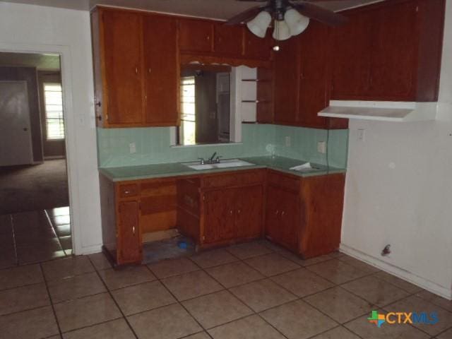 335 Hot Wells Blvd, San Antonio, TX 78223 - kitchen featuring a ceiling fan, healthy amount of natural light, and brown cabinets
