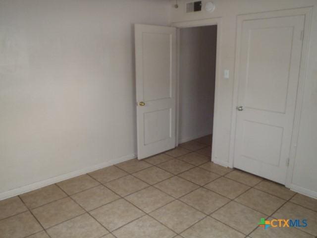 335 Hot Wells Blvd, San Antonio, TX 78223 - spare room with light tile patterned flooring and baseboards