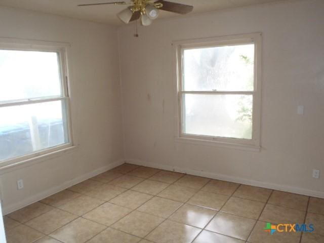 335 Hot Wells Blvd, San Antonio, TX 78223 - unfurnished room with healthy amount of natural light, a ceiling fan, and light tile patterned floors