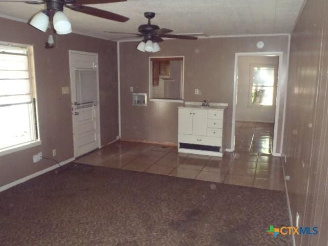 335 Hot Wells Blvd, San Antonio, TX 78223 - tiled empty room with ceiling fan and carpet floors