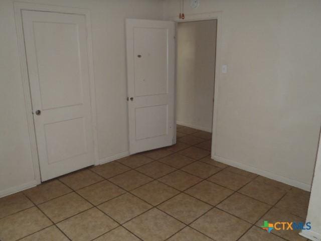 335 Hot Wells Blvd, San Antonio, TX 78223 - unfurnished room with baseboards and light tile patterned flooring
