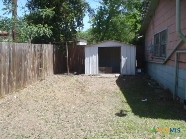 view of shed with fence