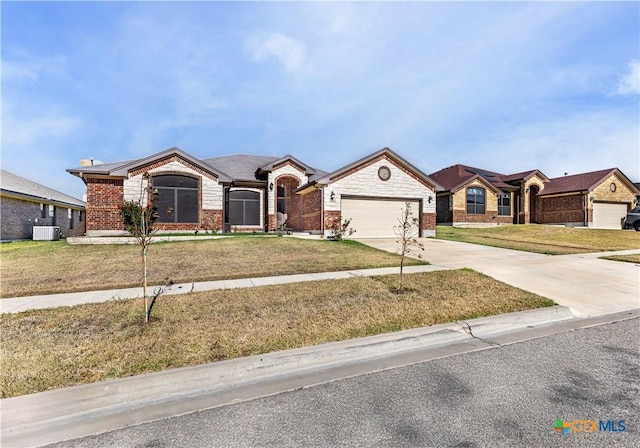 ranch-style home featuring central AC unit, a garage, and a front lawn