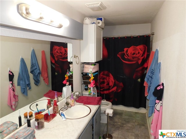 bathroom featuring toilet and vanity