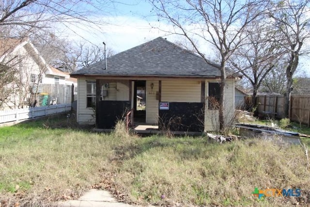 rear view of house featuring an outbuilding