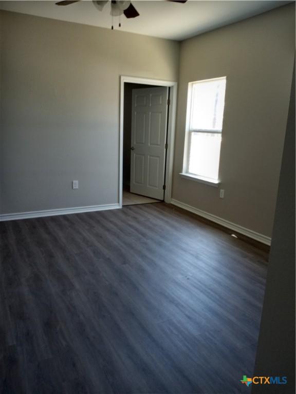 2703 Cardinal St, Victoria, TX 77901 - unfurnished bedroom with dark wood-type flooring and a ceiling fan