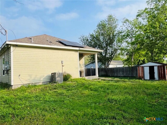 2703 Cardinal St, Victoria, TX 77901 - view of property exterior featuring roof mounted solar panels and a storage unit