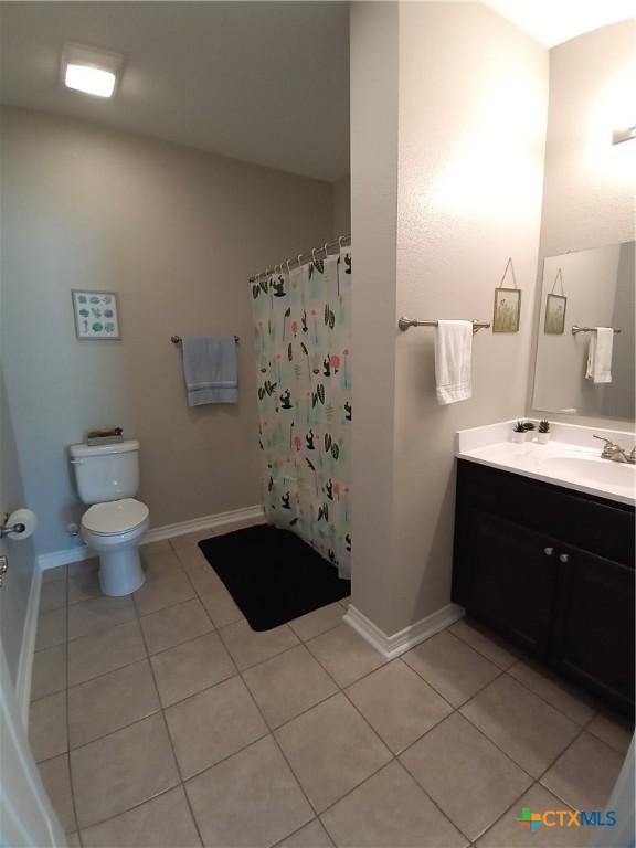 2703 Cardinal St, Victoria, TX 77901 - bathroom featuring tile patterned floors, vanity, and curtained shower