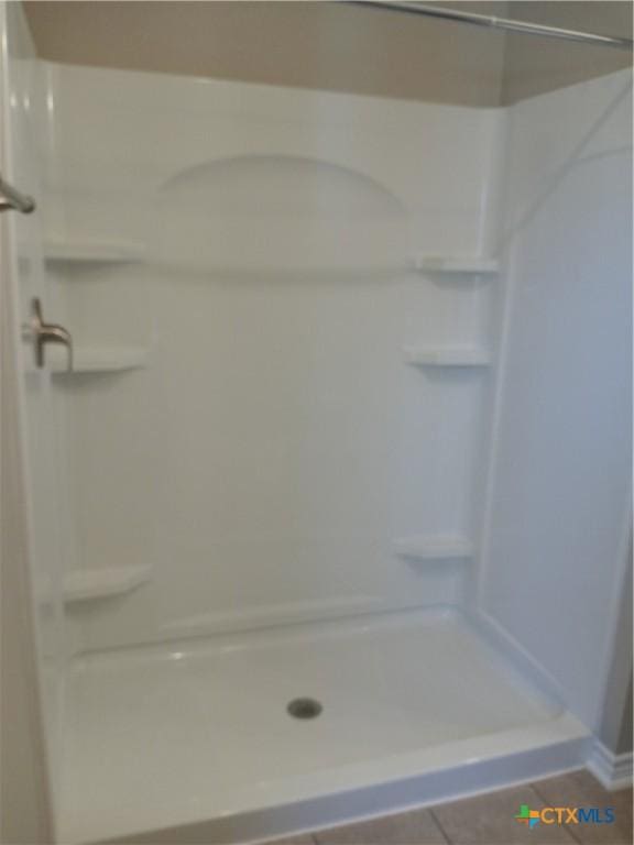 2703 Cardinal St, Victoria, TX 77901 - bathroom featuring a shower stall and tile patterned floors