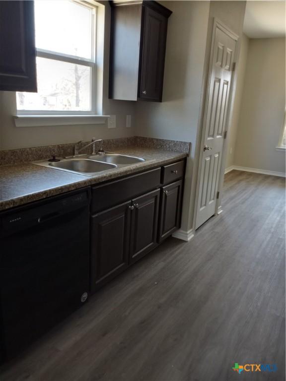 2703 Cardinal St, Victoria, TX 77901 - kitchen featuring dishwasher, dark wood finished floors, and dark countertops