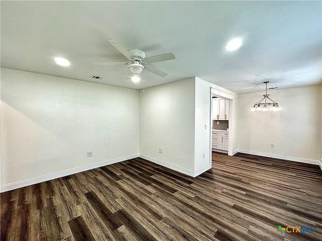 empty room with dark hardwood / wood-style flooring and ceiling fan