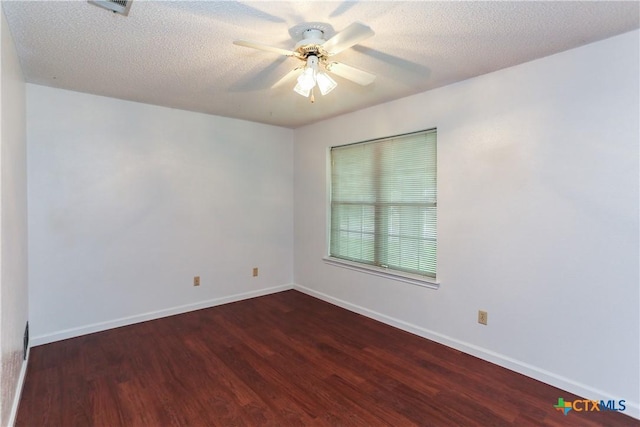 spare room with wood finished floors, ceiling fan, baseboards, and a textured ceiling