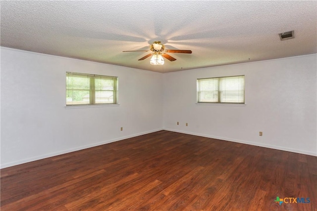 empty room featuring wood finished floors, ceiling fan, a textured ceiling, and baseboards