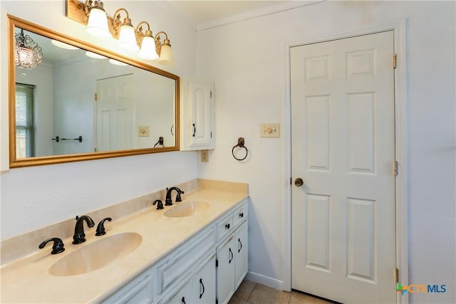 bathroom with double vanity, crown molding, and tile patterned floors