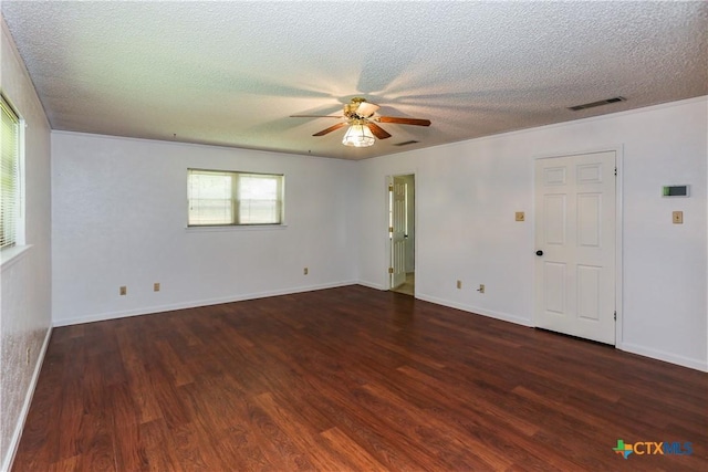 empty room featuring wood finished floors, ceiling fan, a textured ceiling, and baseboards