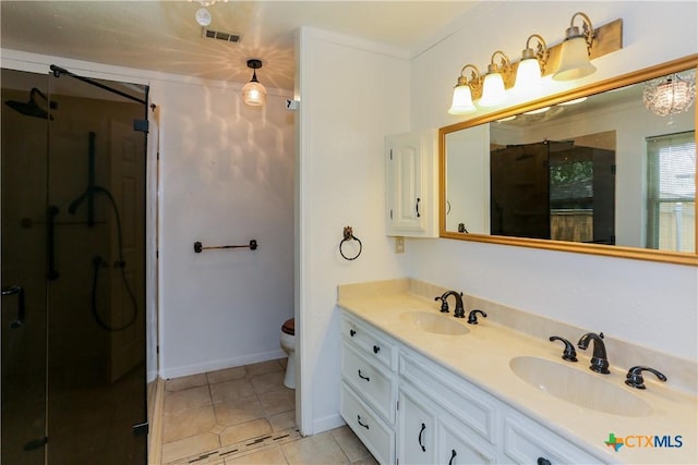 bathroom with a shower stall, toilet, double vanity, tile patterned floors, and baseboards