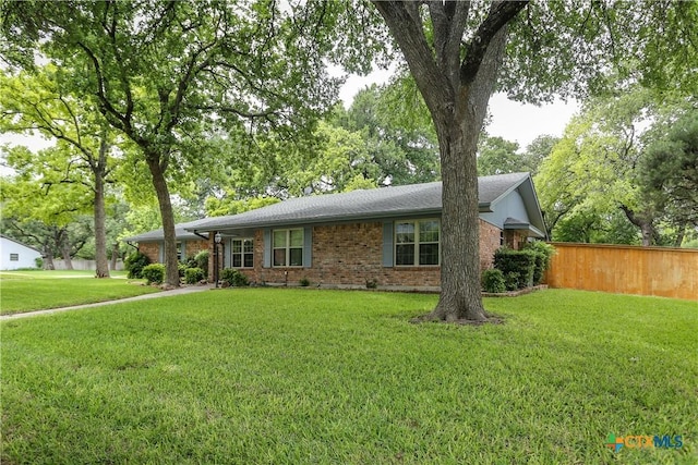 ranch-style home featuring brick siding and roof with shingles