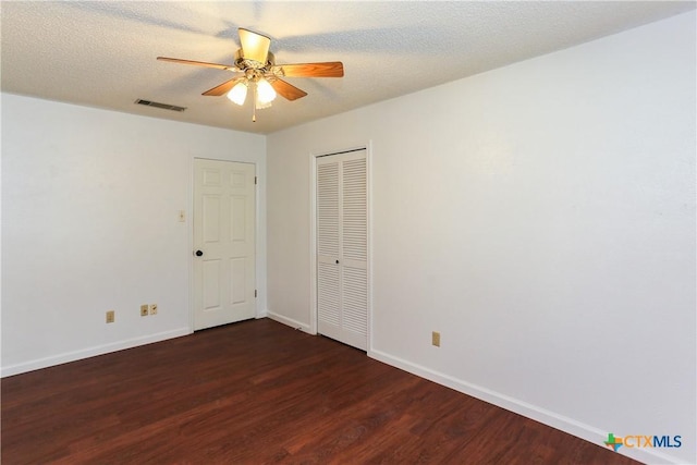 unfurnished room with wood finished floors, ceiling fan, and baseboards