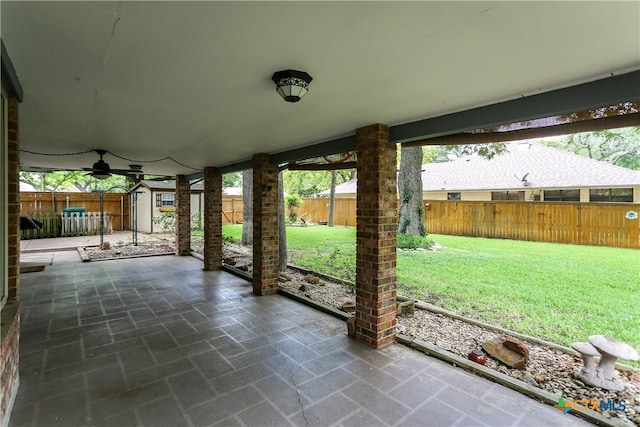 view of patio featuring an outbuilding, a storage shed, and a ceiling fan