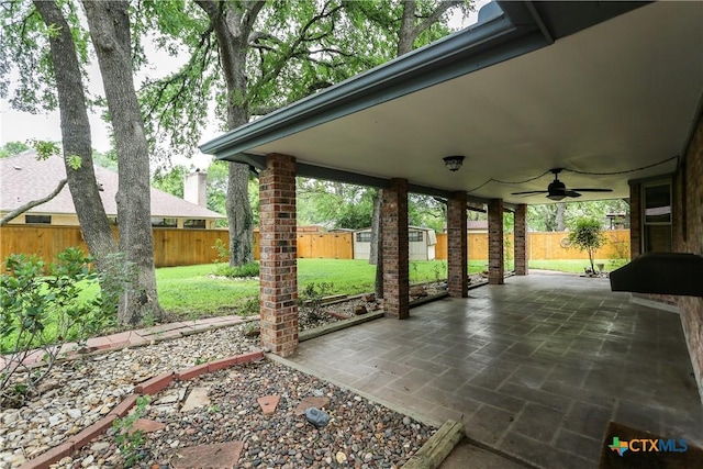 view of patio with a ceiling fan and an outdoor structure