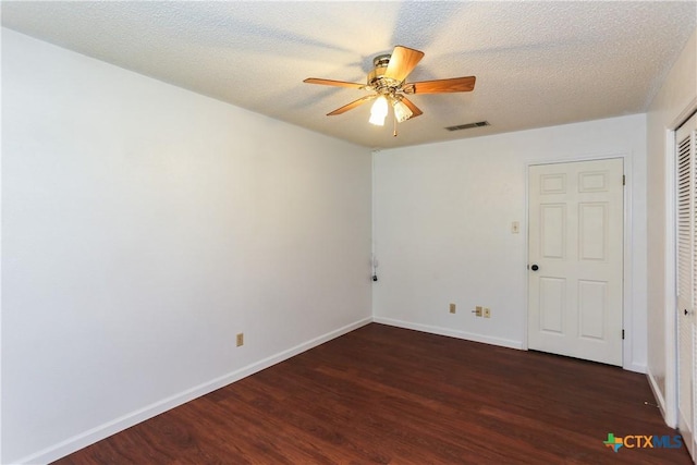 unfurnished room with wood finished floors, a ceiling fan, and baseboards