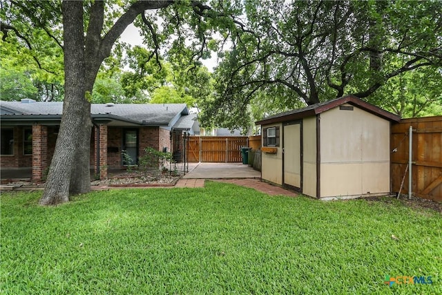 rear view of house with brick siding, an outbuilding, a storage shed, and a patio area