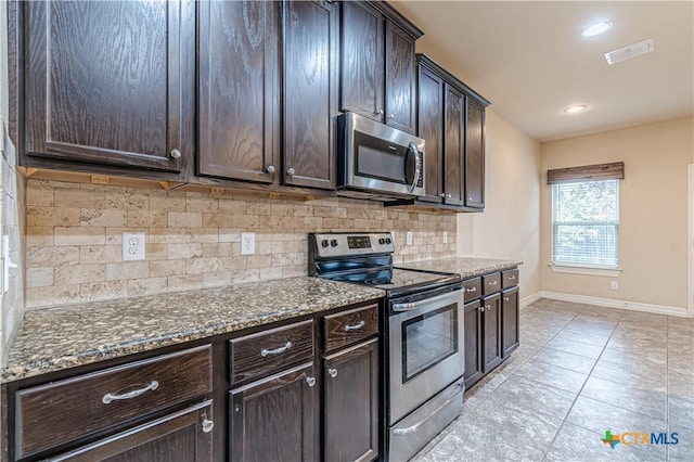 kitchen featuring tasteful backsplash, appliances with stainless steel finishes, and dark brown cabinets