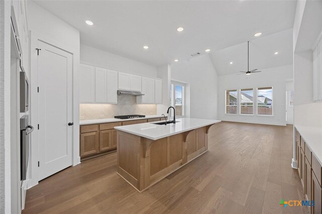 interior space with a towering ceiling and light hardwood / wood-style flooring