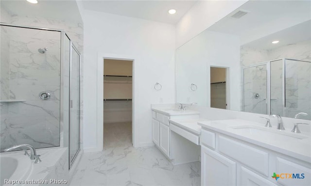 bathroom featuring vanity and separate shower and tub