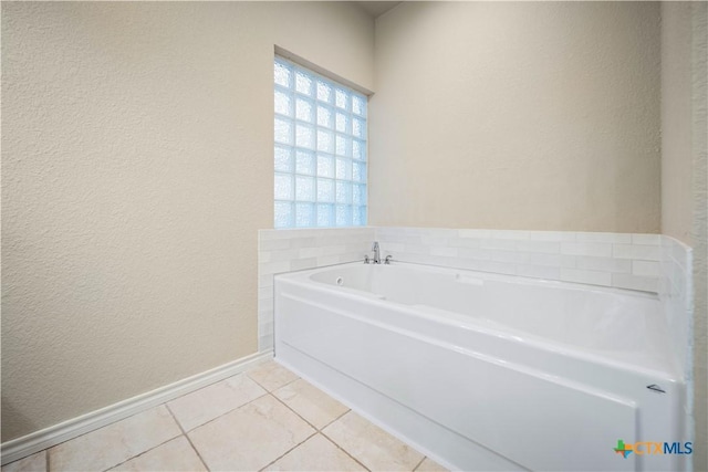 bathroom with tile patterned floors and a bathing tub