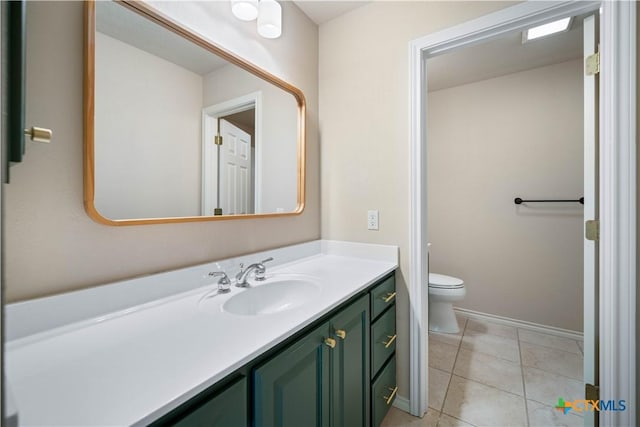 bathroom featuring vanity, toilet, and tile patterned flooring