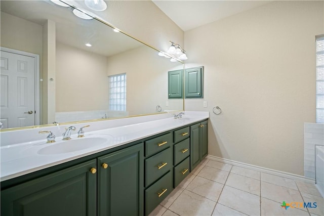 bathroom with tile patterned floors, vanity, and a washtub