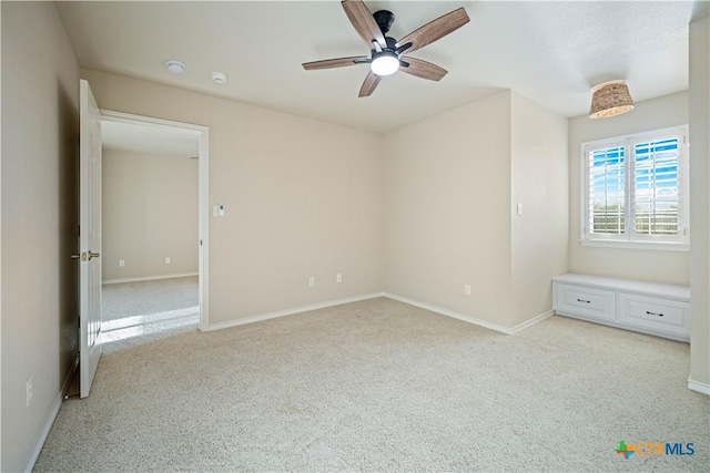 unfurnished bedroom featuring ceiling fan and light carpet