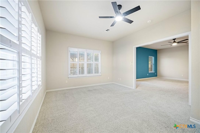 carpeted empty room with ceiling fan