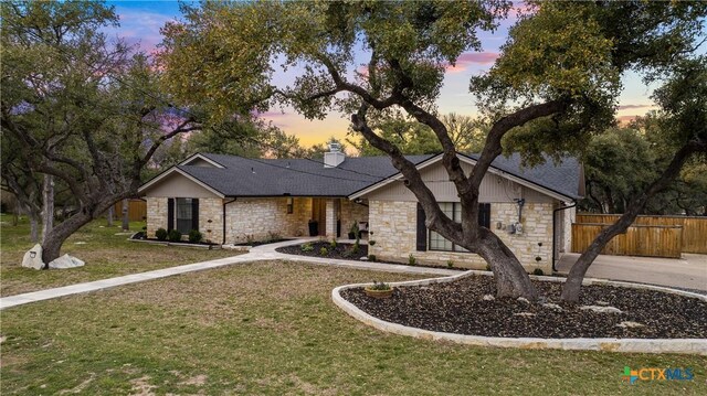 701 W Esparada Dr, Georgetown, TX 78628 - view of front facade featuring stone siding, a chimney, and a shingled roof