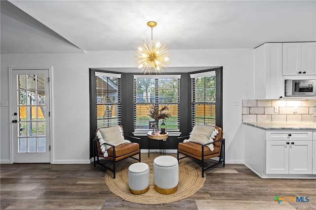 701 W Esparada Dr, Georgetown, TX 78628 - living area featuring a chandelier, dark wood-style floors, and baseboards