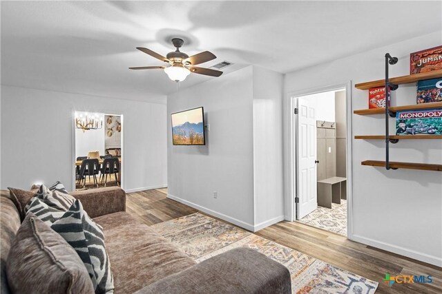 701 W Esparada Dr, Georgetown, TX 78628 - living room with wood finished floors, a ceiling fan, and baseboards