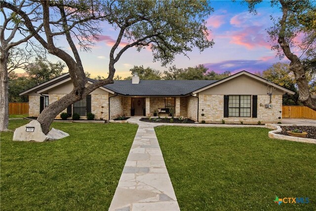 701 W Esparada Dr, Georgetown, TX 78628 - view of front of house with stone siding, a chimney, and a shingled roof