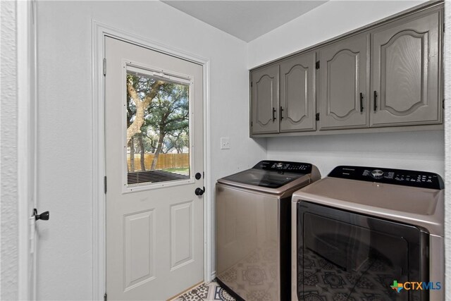 701 W Esparada Dr, Georgetown, TX 78628 - laundry area with cabinet space and separate washer and dryer