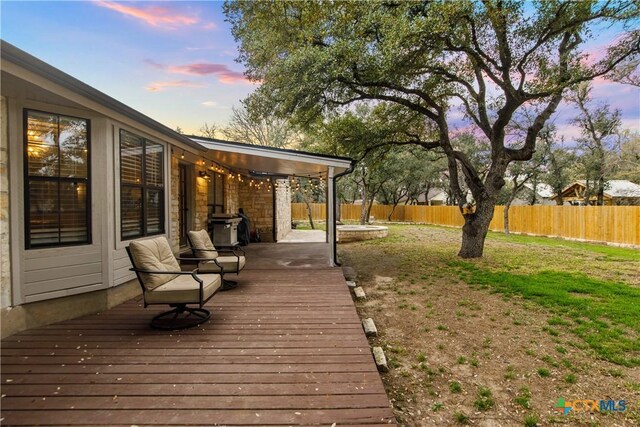 701 W Esparada Dr, Georgetown, TX 78628 - deck at dusk featuring a fenced backyard
