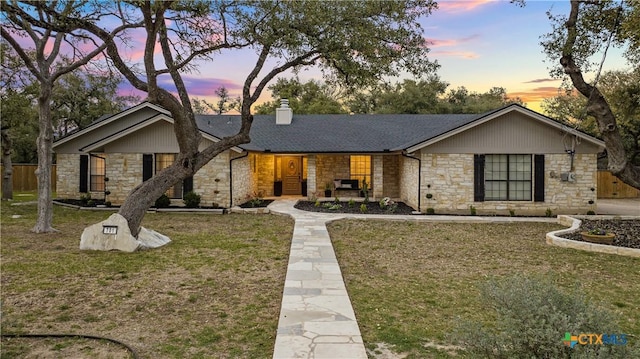 701 W Esparada Dr, Georgetown, TX 78628 - view of front of property with stone siding, a chimney, and roof with shingles