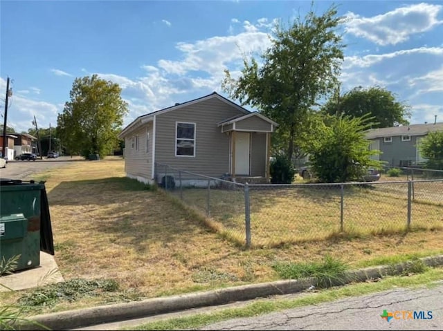 bungalow-style home featuring a front yard and fence