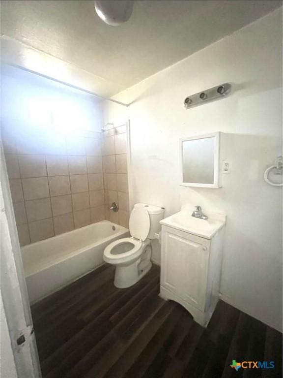 full bathroom featuring wood finished floors, toilet, and vanity